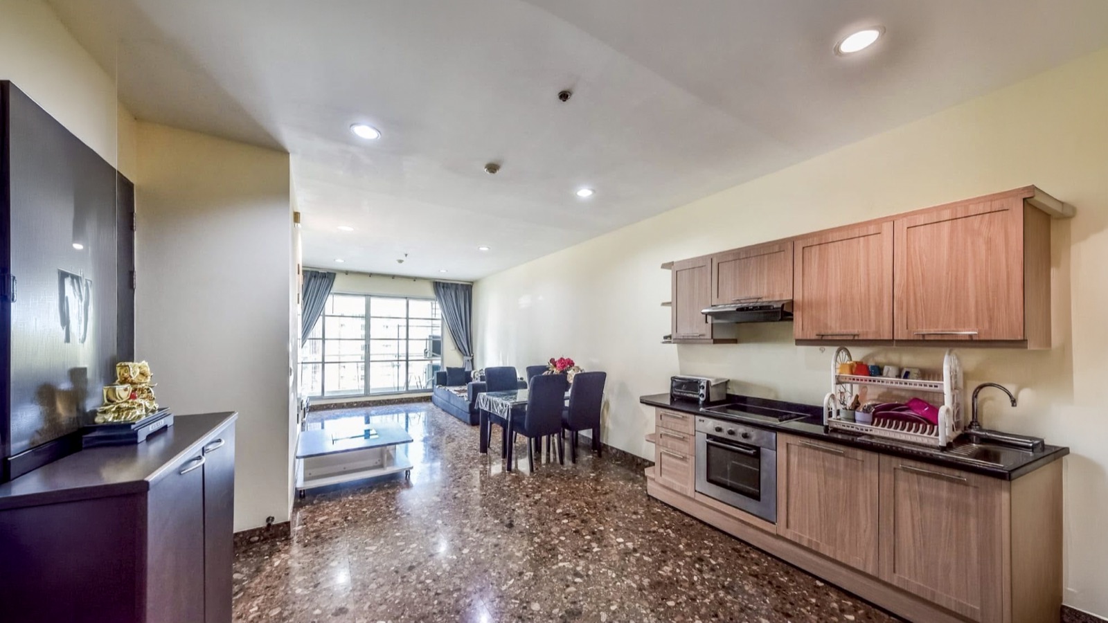 Long view from the fitted kitchen through the dining area to the living room