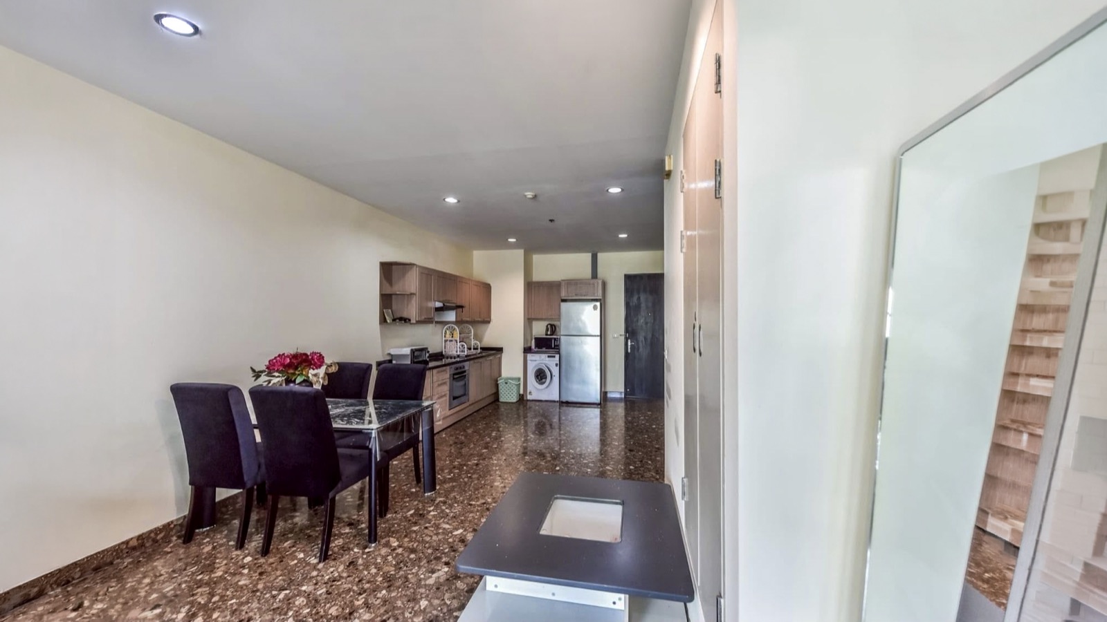 Dining area looking toward the fitted kitchen and condominium entrance